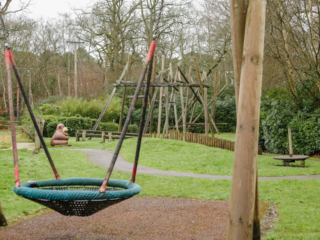 Image of wooden climbing frames and basket swing at edenbrook play area taken on an overcast day