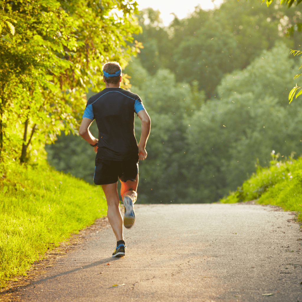 Image of a man running on a path through a park