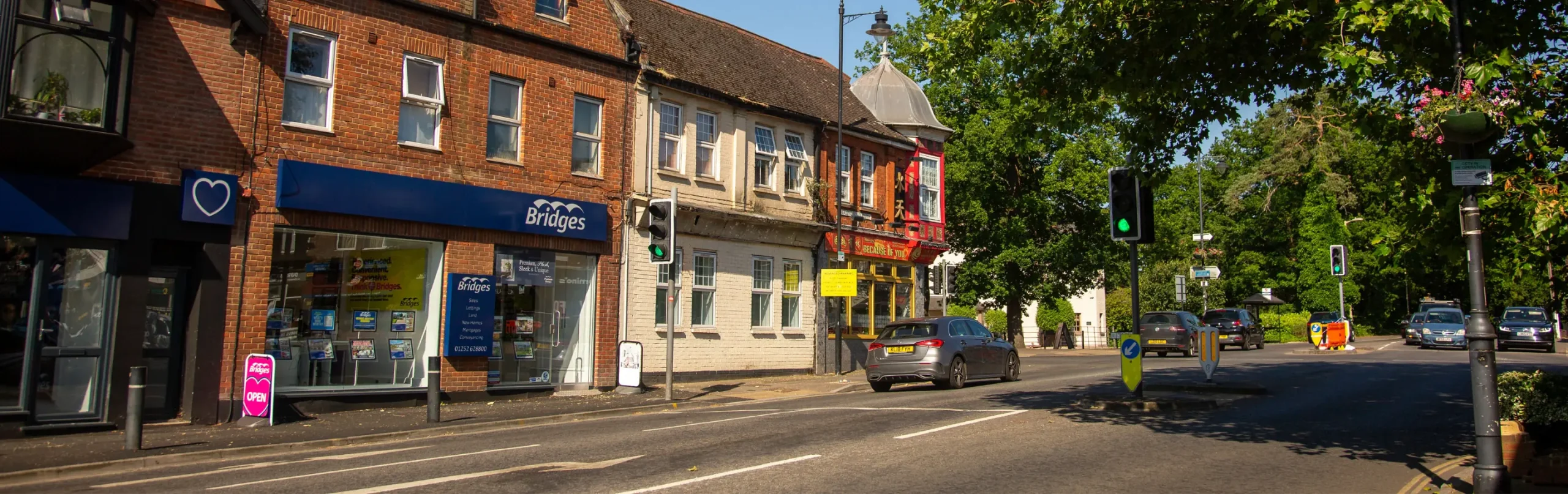 Image of fleet high street showing restaurants, cars and bright floral displays