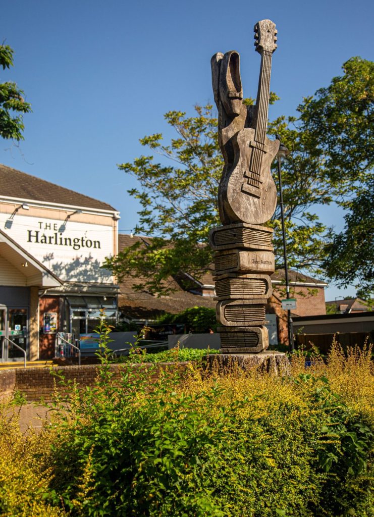 Image of a tree carving outside The Harlington
