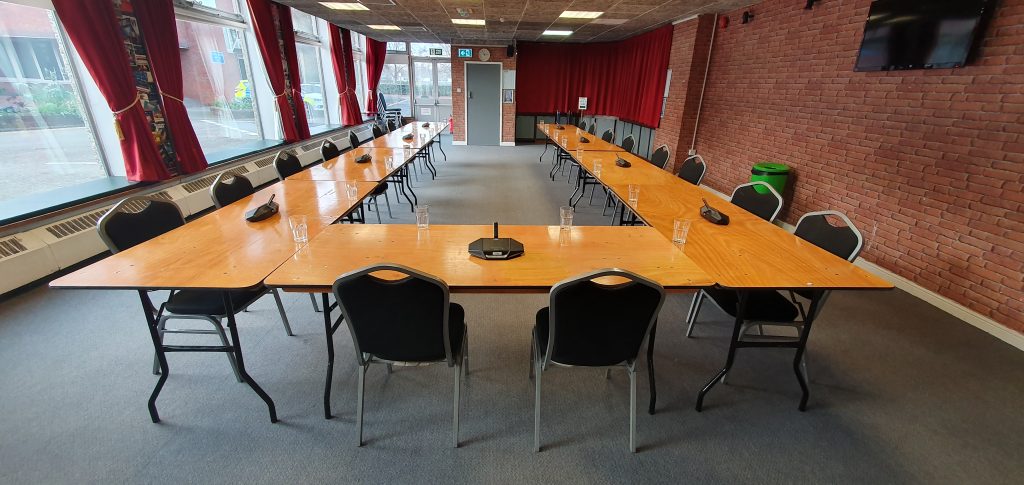 Image of tables set up for a council meeting in The Harlington Function Room