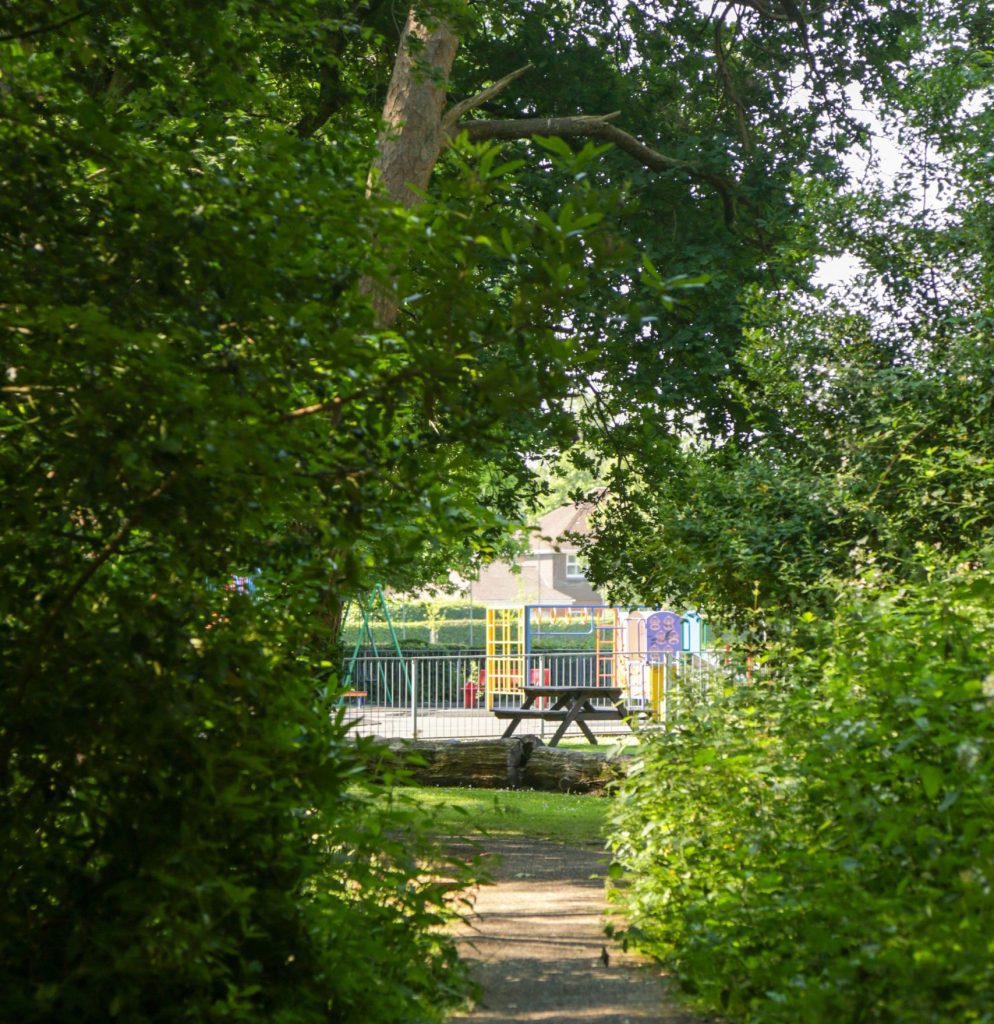Image of play equipment and picnic bench at Oakley Park