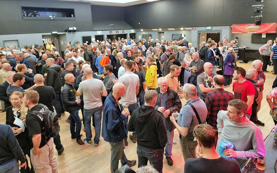 Image of people drinking beer in a hall at lions beerfest event