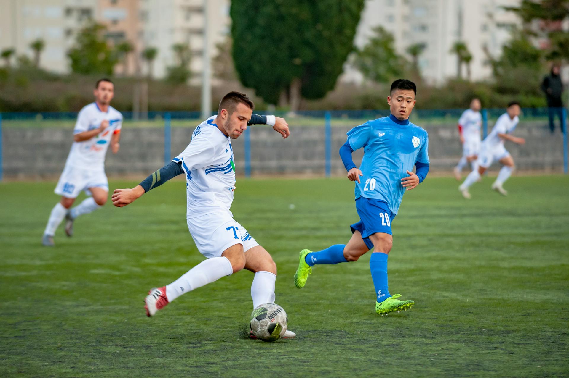 Image of men playing football on a pitch