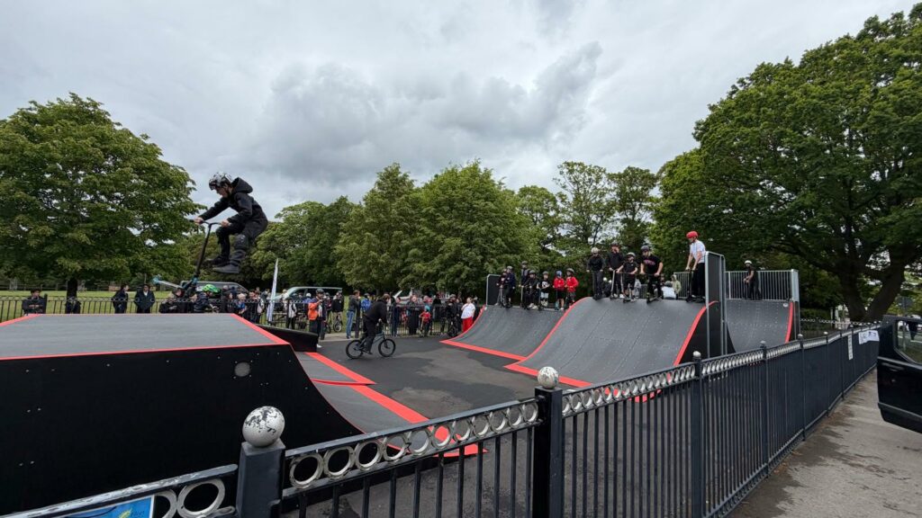 photo of new skatepark with kids using the ramps
