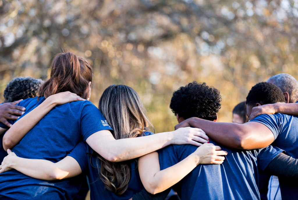 image of team linking arms